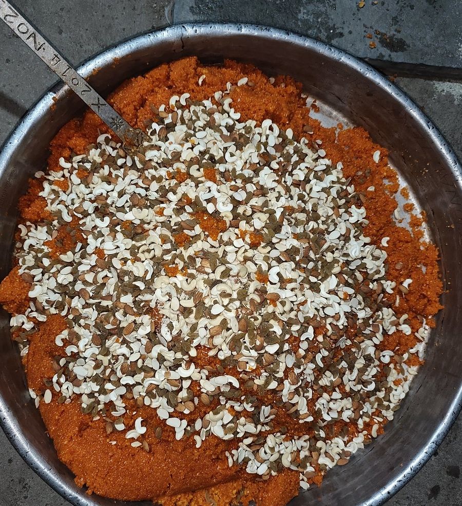 Motichoor mixture being folded together with dry fruits